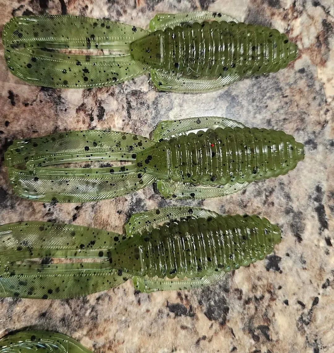 Three green pumpkin craws with black flake and flapping claws